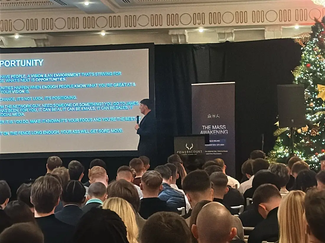 A full ballroom at Luttrellstown Castle, Dublin, with a speaker on stage