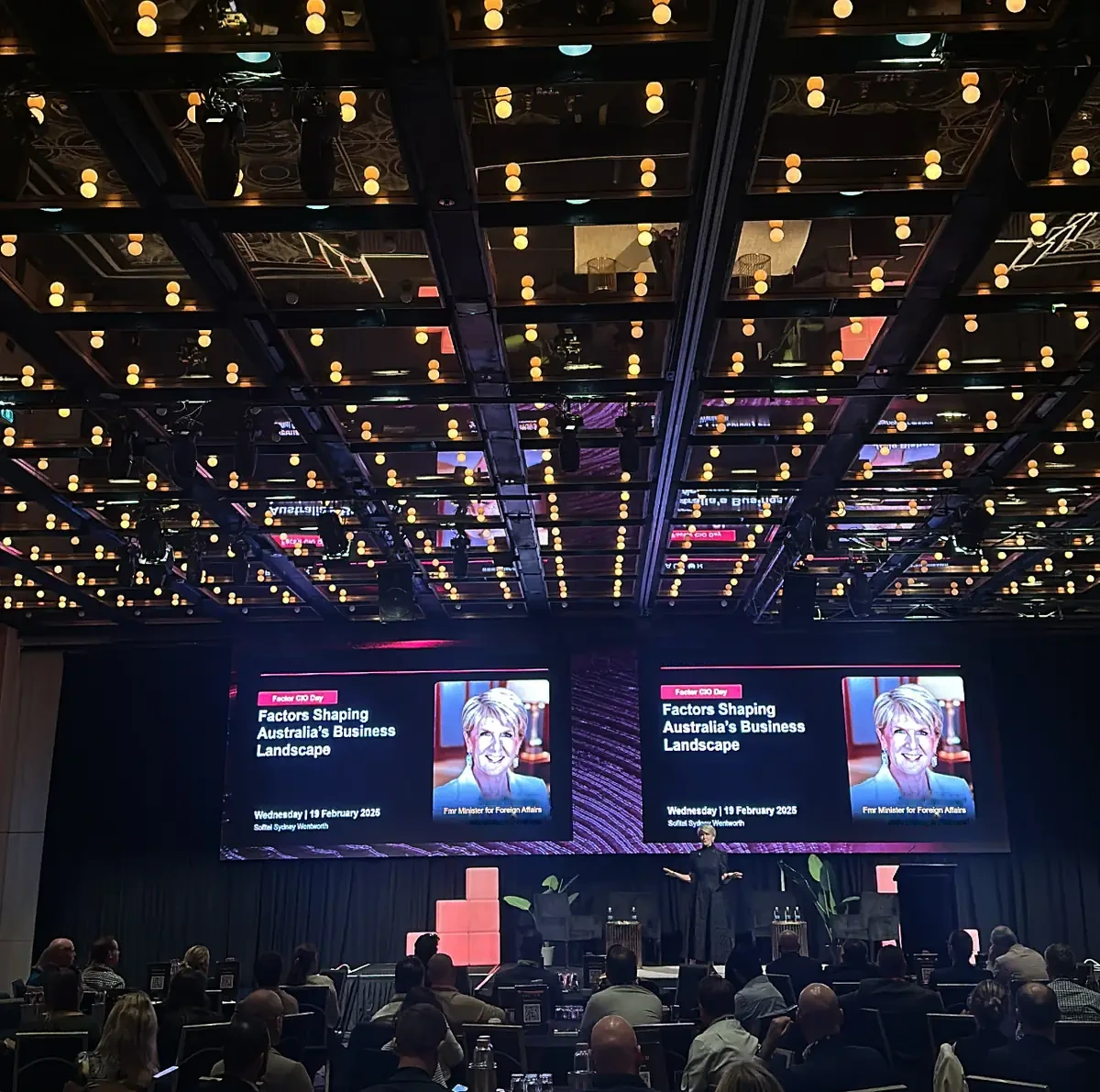 A Sydney ballroom on a conference day, lit from above
